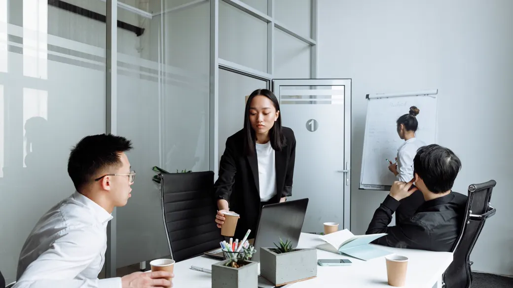 Văn phòng công ty, nhân viên làm việc và một người trình bày trên bảng, giai đoạn lên doanh nghiệp